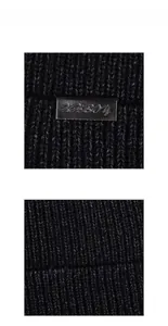 Detail shot of black ribbed knit beanie featuring an XHBOU brand logo metal plaque