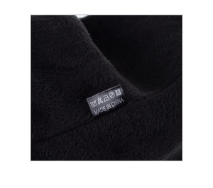 Detailed macro view of the thick black fleece lining and care label on the winter knit hat