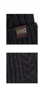 Detailed macro view of cable knit pattern and leather metal brand tag on the winter beanie