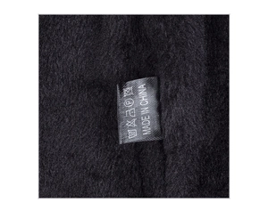 Detail shot of the soft black plush lining and wash care label on this winter knit hat