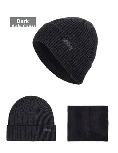 Detail view of dark heather grey waffle knit winter beanie hat and matching neck warmer set