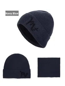 Detail of navy blue winter knit beanie and neck warmer set with embroidery