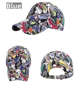 Detailed view of blue baseball cap featuring vibrant graffiti prints and metal back buckle