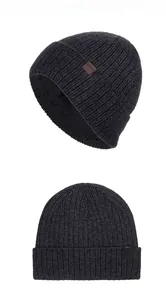 Detailed view of the dark grey knit beanie featuring a thick fleece lining and logo patch