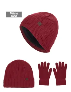 Detailed view of wine red cable knit beanie with warm fleece lining and matching gloves