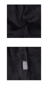 Macro detail of black knit beanie fabric showing 45% acrylic material composition label