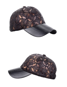 Detail view of baseball cap featuring bronze metallic patterns and black leather brim