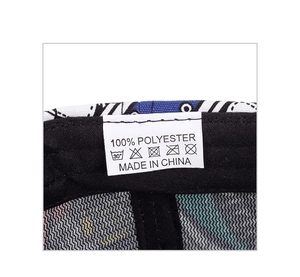 Macro shot of 100% polyester material label and wash care icons on baseball cap