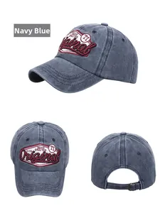 Detail view of navy blue washed cotton baseball cap with vintage embroidery and metal buckle