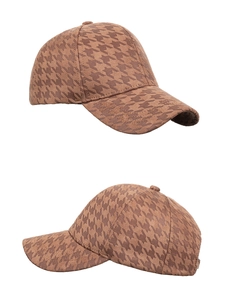 Detail view of brown houndstooth baseball cap showing classic fabric texture and stitching