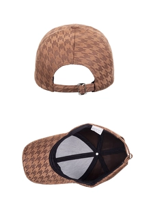 Detail view of coffee houndstooth baseball cap showing adjustable silver metal buckle