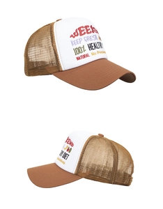 Close-up of WEEKEND embroidery and brown mesh texture on a contrast baseball cap