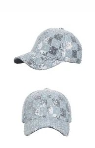Detail view of denim baseball cap with silver sequins and distressed fringe finish