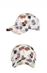 Detail of white baseball cap with purple and gold floral print for sun protection