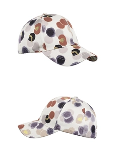 Detail of floral printed baseball cap featuring gold sequins and adjustable strap