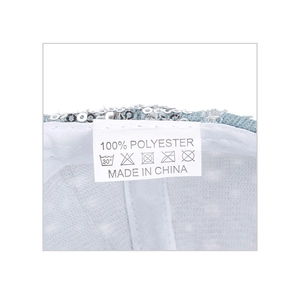 Detailed macro view of the interior wash label and silver sequins on a denim hat