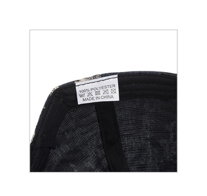 Close-up of the wash care label showing 100% polyester and maintenance icons on the cap