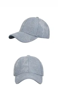 Detail view of sparkly sequin baseball cap in grey blue with shimmering textured surface