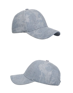 Detailed view of shiny sequin texture and stitching on the light blue baseball cap