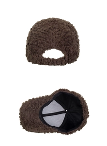 Detail view of brown sherpa fleece baseball cap showing textured exterior and black lining