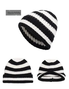Detail view of black and white striped knit beanie showing texture and inner folded brim