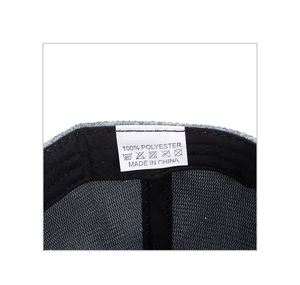 Detail shot of internal wash label on sequin baseball cap showing 100% polyester fabric