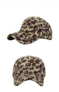 Detail view of leopard print faux fur baseball cap in plush brown and black tones