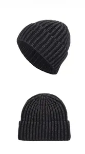 Detailed vertical knit texture on dark gray winter beanie hat with classic cuffed design