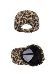 Detail view of leopard print plush baseball cap showing back closure and inner lining