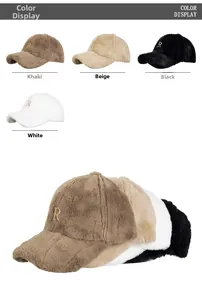 Close-up of fluffy faux rabbit fur texture and metallic letter R embroidery on baseball caps