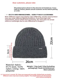 Detail of dark grey wool knit beanie with 81.1% sheep wool texture and metal tag