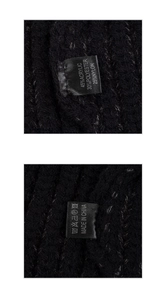 Detailed material tag of the black knit hat showing acrylic, polyester and nylon blend