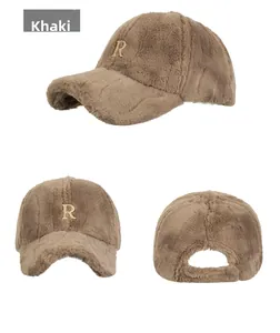 Close-up of khaki plush baseball cap featuring a golden metal R letter decoration
