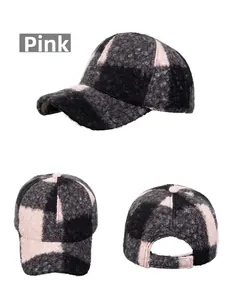 Detailed views of the pink and black plaid baseball cap with bouclé texture and curved brim