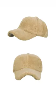 Close-up detail of plush camel baseball cap featuring soft faux fur texture and warm fabric