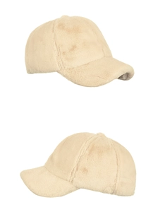 Detail view of plush faux fur baseball caps in beige, showing soft texture and stitching
