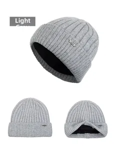 Detail view of light gray knit beanie with warm black fleece lining and ribbed texture