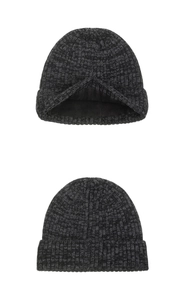 Close-up of thick ribbed knit texture and warm black fleece lining on a winter beanie hat