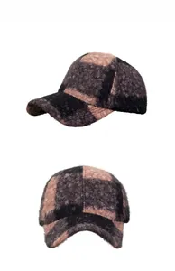 Detail of checkered plaid baseball cap showing thick warm wool texture and stitching