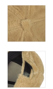 Detailed close-up of light brown plush baseball cap seams and black adjustable velcro strap