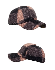 Close-up of checkerboard baseball cap featuring warm textured sherpa fleece fabric