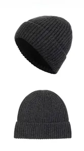 Detail view of dark grey winter beanie with thick vertical knit ribbing and folded cuff