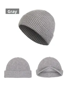 Detail view of grey ribbed knit beanie showing textured weave and interior structure
