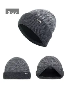 Detail view of gray knit beanie with warm fleece lining and metal logo decoration