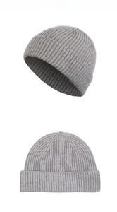 Detailed view of gray rib-knitted beanie showing vertical texture and wide folded cuff