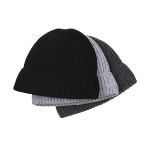 Three winter knit beanies in black and grey shades featuring thick ribbed texture and warm fleece