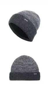 Detailed view of the thick knit texture and silver metal logo on a grey wool beanie