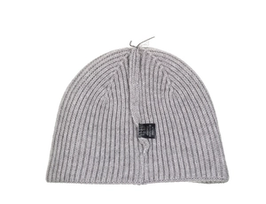 Detail of grey ribbed beanie showing material tag and premium knit seam texture