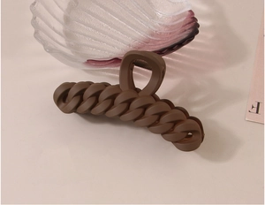 Detail view of a 11cm matte coffee chain hair claw clip with a strong metal spring