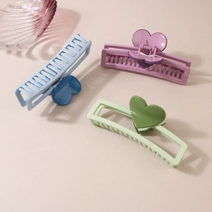 Three elegant large heart hair claws in light blue, lavender, and green for women's updos